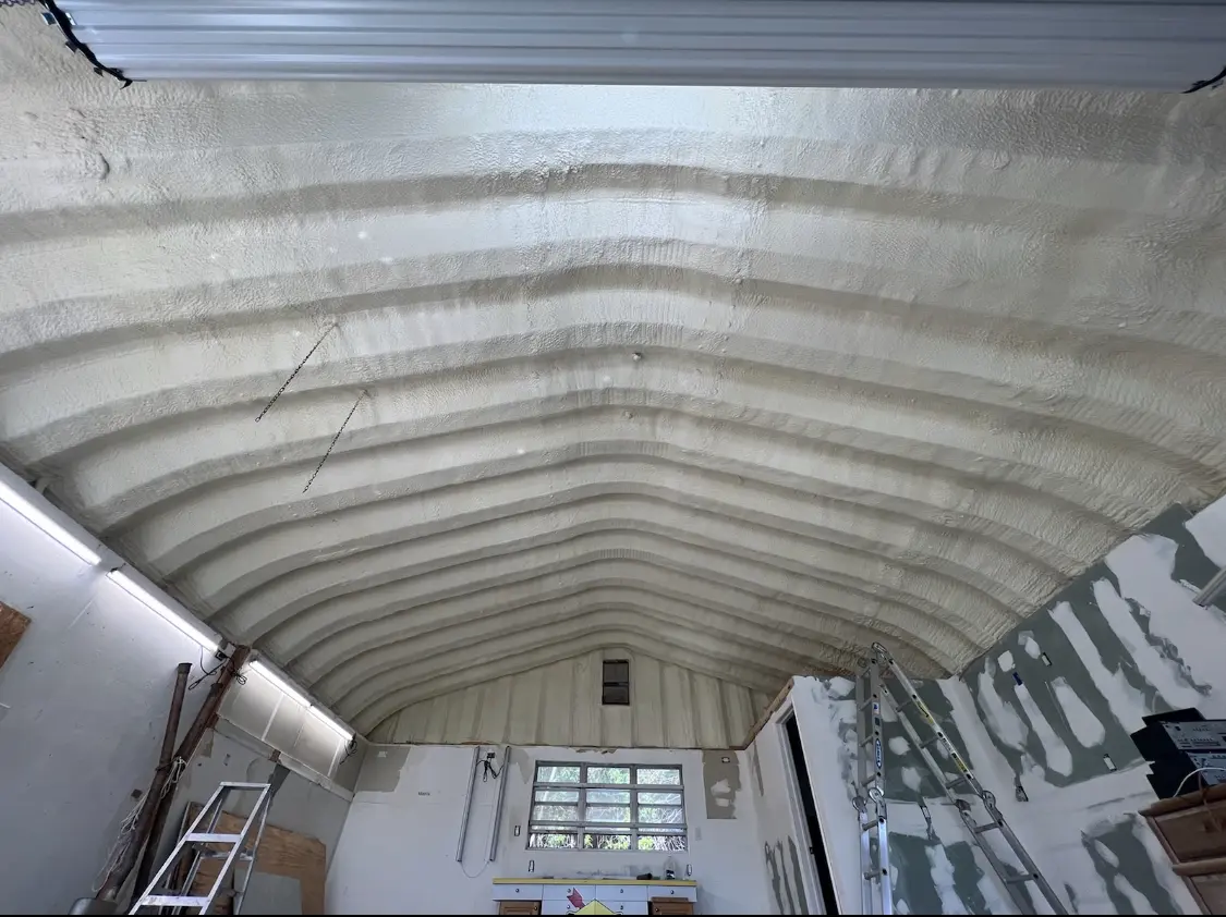 Spray polyurethane foam applied to the underside of a metal roof deck in Saco